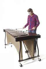 teenage boy playing marimba in studio