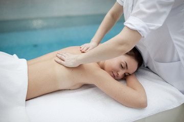 Young woman getting a massage in a spa 