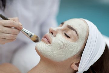 A young woman with a face pack. 