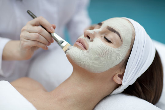 A young woman with a face pack. 