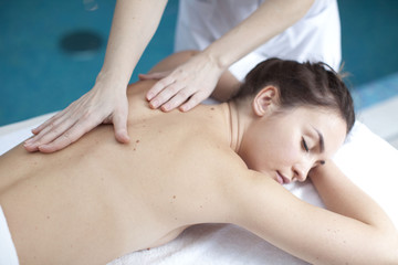 Fototapeta na wymiar Young woman getting a massage in a spa 
