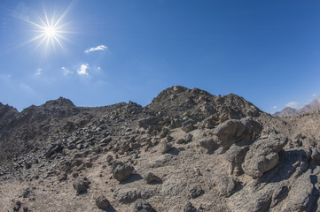 Fototapeta na wymiar Rocky desert mountain with blue sky background