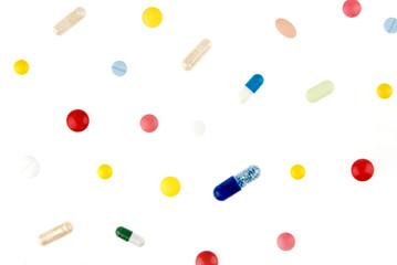 Color pills and capsules background isolated on white background
