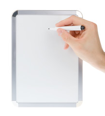 Holding and writing on empty whiteboard isolated on white