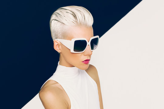 Blonde Model In Trendy Sunglasses With Stylish Haircut. Fashion