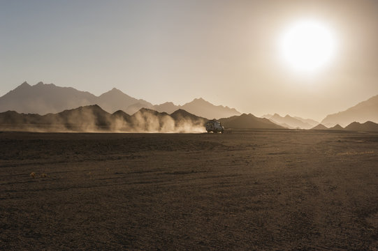 Fototapeta Off road safari in desert with sunset