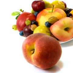 Isolated image of various fresh fruits on the plate closeup