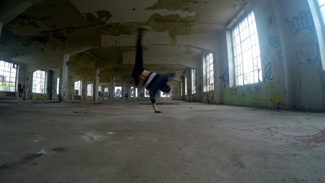 Young boy dancing breakdance in the old hall, 4K