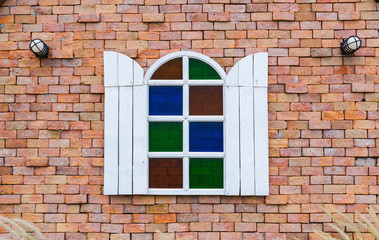 white window on  brick wall