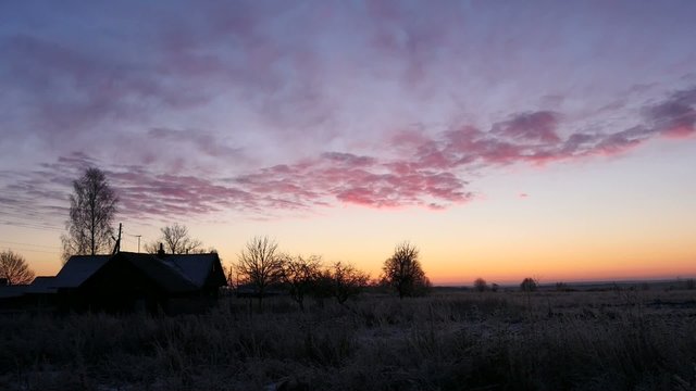 Old village frosty morning and pink clouds, time lapse.