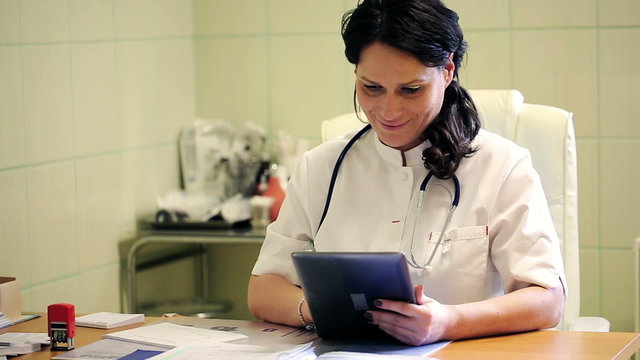 Female doctor working with tablet in the office