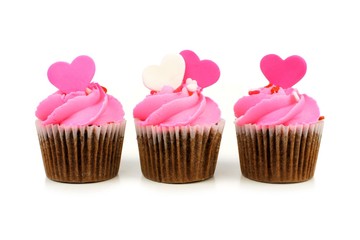 Chocolate Valentines Day cupcakes with pink frosting and hearts