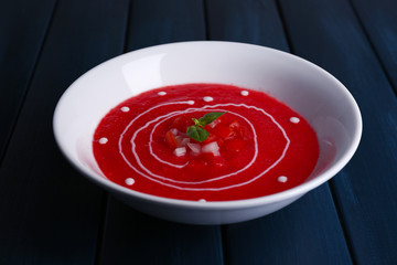 Gazpacho soup on color wooden background