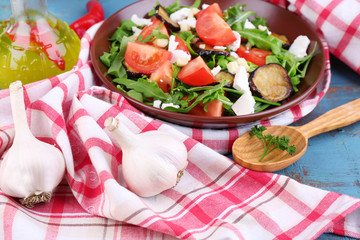 Eggplant salad with tomatoes, arugula and feta cheese,