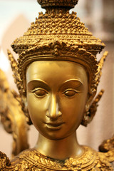 golden thai statue woman face closeup
