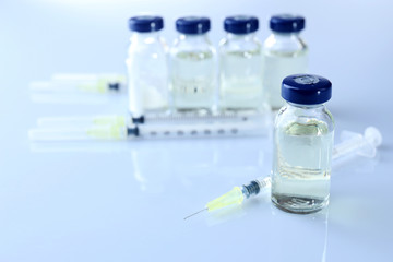 Vaccine in vial with syringe