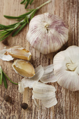 Raw garlic and spices on wooden table