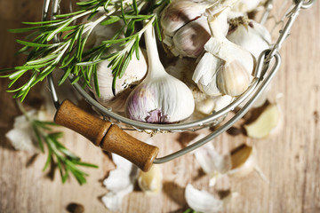 Raw garlic and spices on wooden table