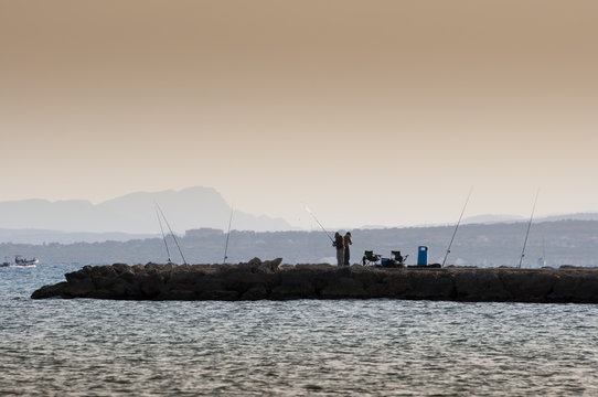 Beach fishing from the breakwater in Santa Pola, Alicante,