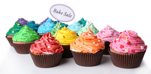 Delicious cupcakes with inscription isolated on white