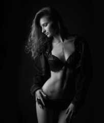 Fototapeta premium silhouette of a sexy woman in the lower black lingerie