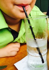 boy drinking a glass of water