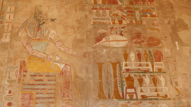 ancient egypt color images on wall in luxor - tilt view