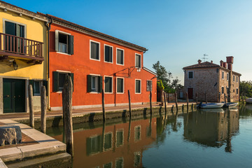 Fototapeta na wymiar Colorful houses along a canal,Torcello island, Venice, Italy
