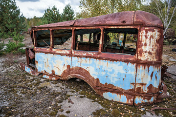 rusty bus on junk yard near Illinci village in Chernobyl Zone