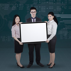 Fototapeta na wymiar Entrepreneurs with whiteboard and financial background
