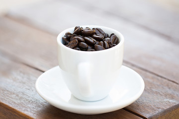 Coffee beans in coffee cup