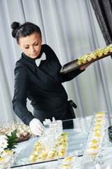 Waiter serving catering table