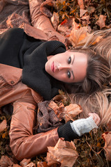 Girl lying on the autumn leaves