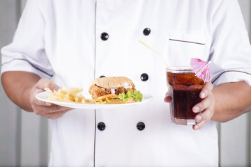 chef present a burger and cola