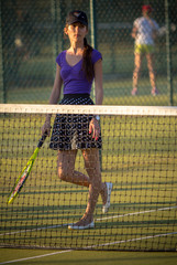 Attractive young girl playing tennis