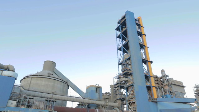Establishing shot of a cement factory. Panning shot.