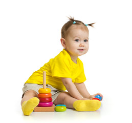 baby playing with colorful tower isolated