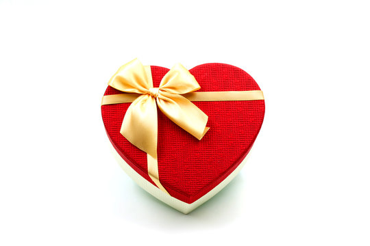 A Heat-Shaped Red Gift Box with Golden Ribbon and Bow