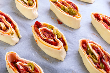 Swiss roll pastry stuffed with ham, olives and sundried tomatoes