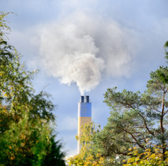 Heavy sunlit smoke and chimney