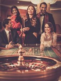 Group of stylish people playing in a casino