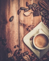 Coffee cup on a wooden table among coffee beans