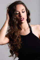 Brunette woman with long hair wearing black t-shirt