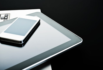 keyboard with phone and tablet pc on black background