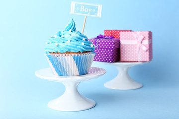 Delicious cupcake with inscription on blue background