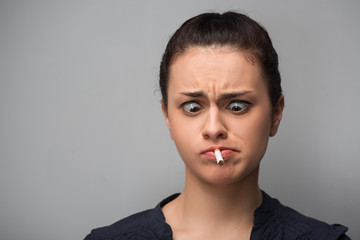 Addiction. Closeup of young woman determined girl holding cigare