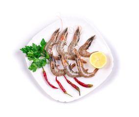Raw tiger shrimps on plate.