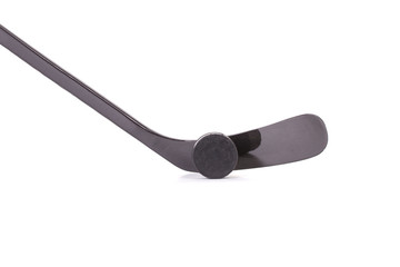 Black ice hockey stick and puck.