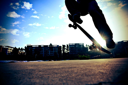 skateboarding legs jump in the city 