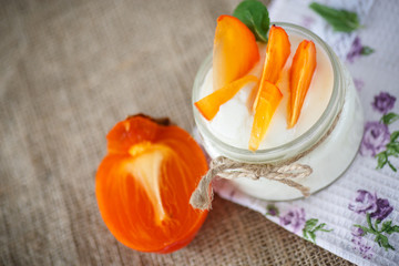 Fototapeta na wymiar sweet homemade yogurt with persimmons